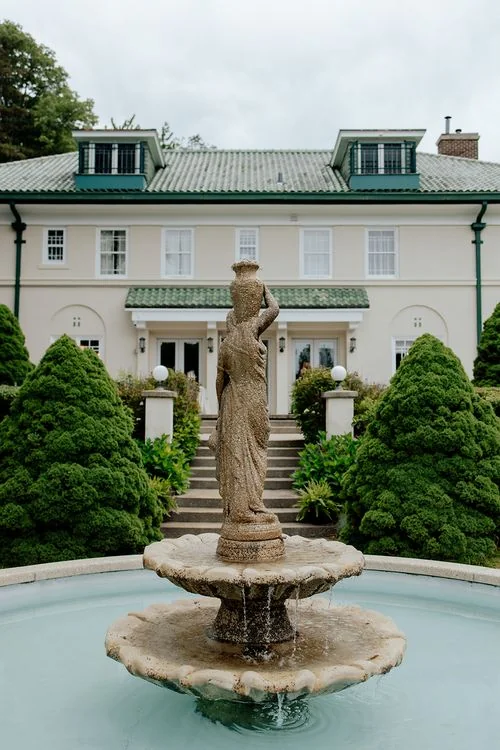 Belvedere Estate & Gardens in Saugatuck, MI: the historic 1912 villa behind its tiered stone fountain and sculpted evergreens